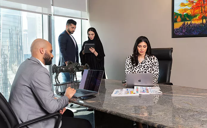 Servcorp Meeting Room with people meeting and presenting using high-tech, fully equipped facilities.