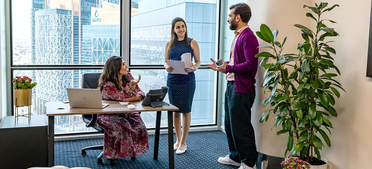 Clients brainstorming in a fully equipped serviced office with a city view at Servcorp’s Commercial Bank Plaza.